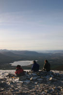07-4701 Three Walkers Enjoying the Winter View Over Loch Morlich From Meall a' Bhauchaille Cairngorms Scotland